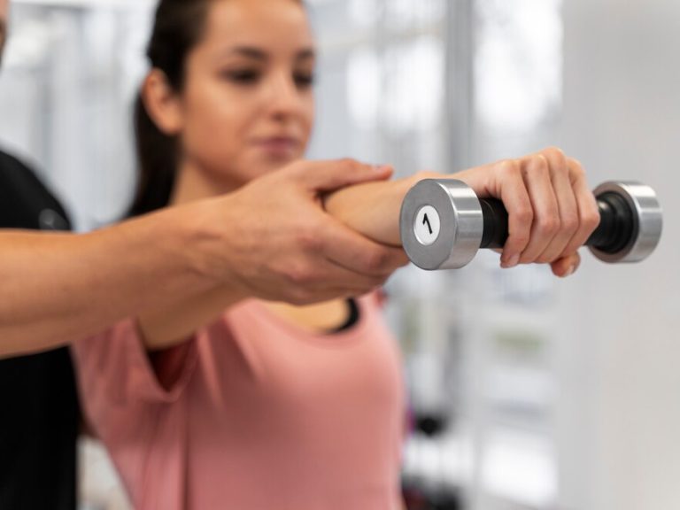 blurry-woman-exercising-with-dumbbell-close-up_23-2149178071